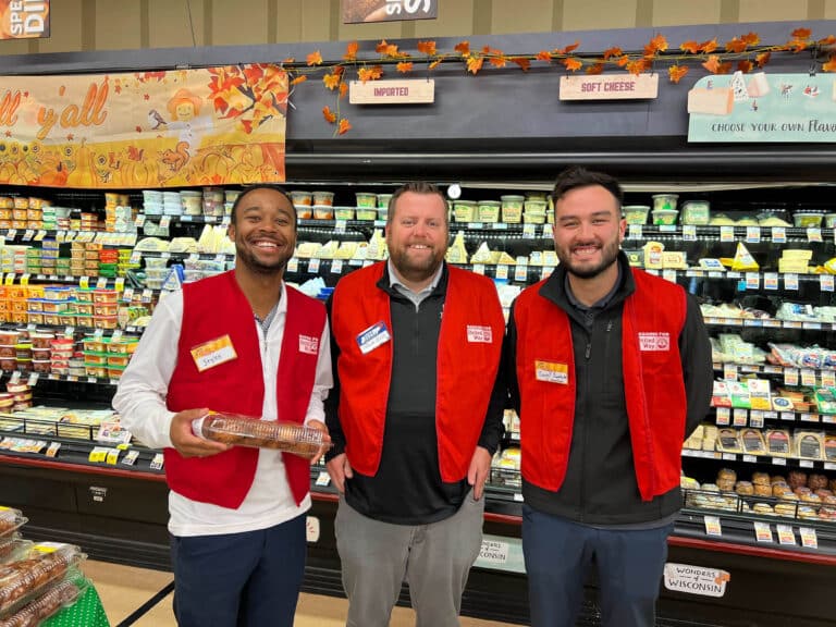 A group of three volunteers wearing red United Way vests.
